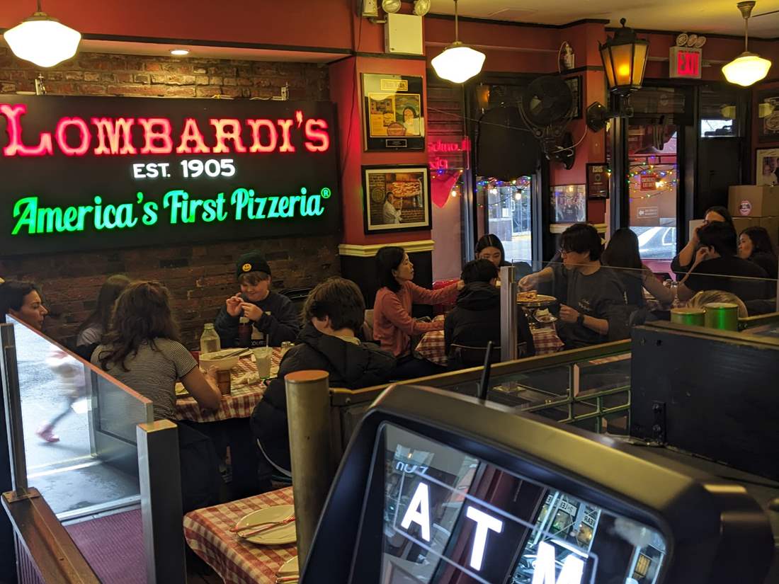 Lombardi's pizzeria interior dining with guests enjoying our famous pizza. 