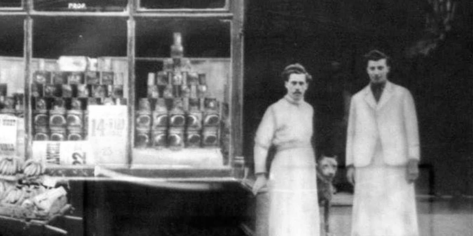 old photo of original owners standing in front of store